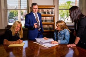 Team group reviewed documents at office desk