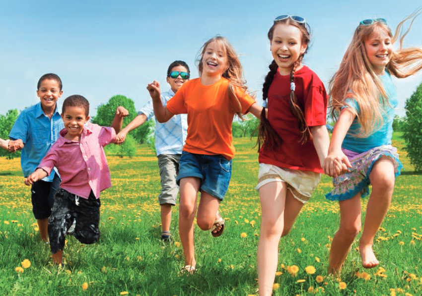 children running together in field during summer