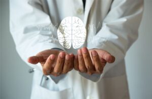 Doctor holding a brain model with brain waves illustration, symbolizing health care concepts.