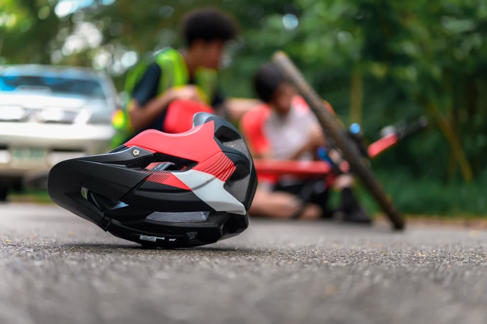 Close-up of a bicycle helmet on the street after a mountain bike accident, cyclist awaiting first aid assistance