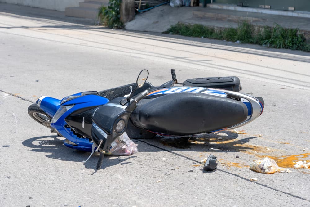 Damaged motorcycle on the road after traffic accident