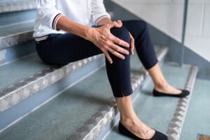 Mature Woman Sitting On walmart Staircase After Slip And Fall Accident