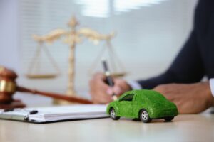 In a courtroom, a judge with a gavel oversees a car accident case as lawyers present evidence and documents, influencing insurance claims and legal outcomes.