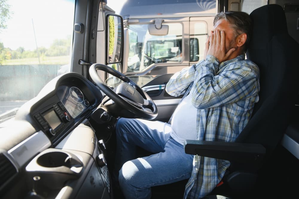 Portrait of tired truck driver feeling sleepy and sick.