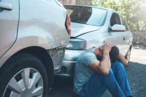 Sad passenger after car crash on the road