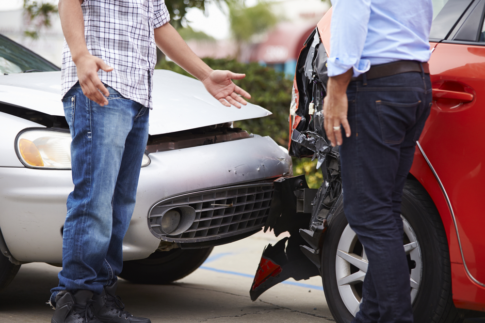 Two drivers discuss a rear-end collision at the scene while assessing who is at fault.
