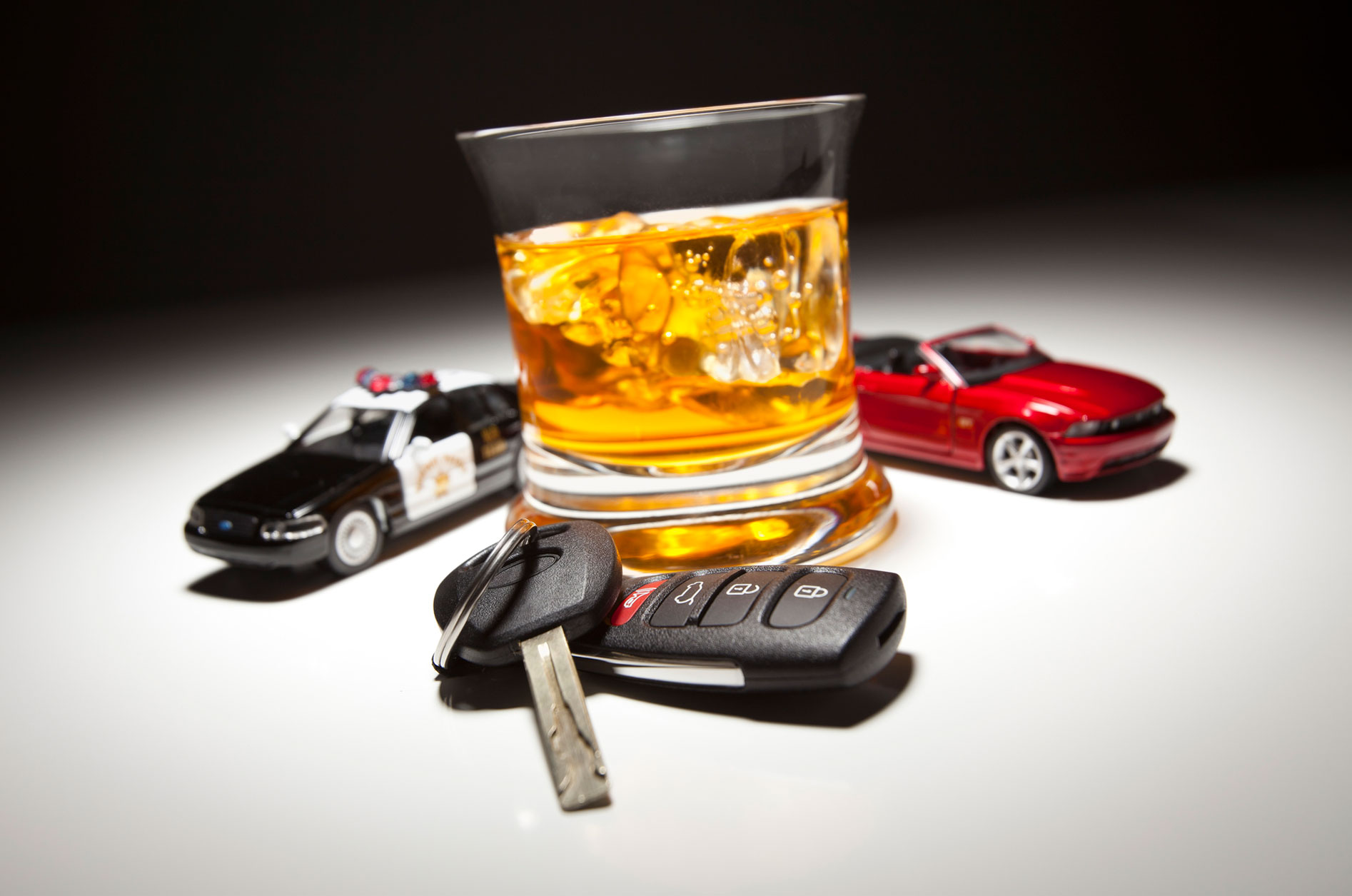 Police traffic stop and alcohol with car keys concept image, representing DUI enforcement and punitive damages in Pennsylvania drunk driving crash claims